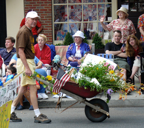 paul walking with wheelbarrow in parade
